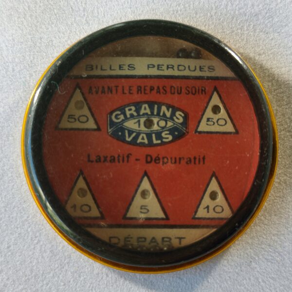 Grains de Vals, jeu de billes (fond rouge) et, au dos, publicité. Sans miroir.