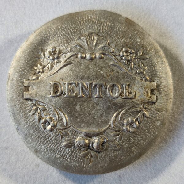 "Dentol", tout petit miroir rond (diamètre 3,5 cm).