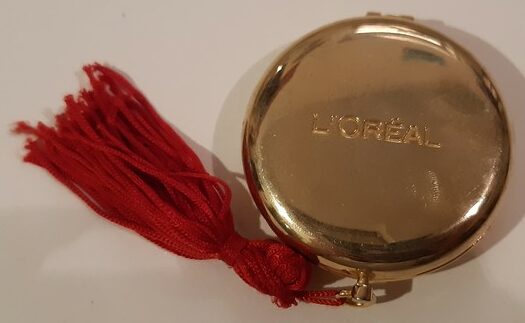 "L'Oréal"miroir rond, ouvrant, biface, façon montre gousset, métal doré bombé. (double)